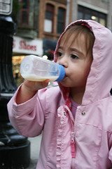 Little girl drinking milk from her bottle