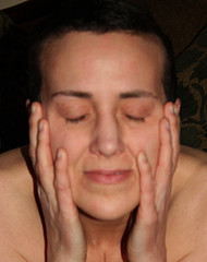 A lady holding her face with both hands
