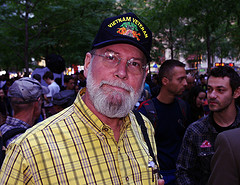 A senior citizen with white beard and black cap